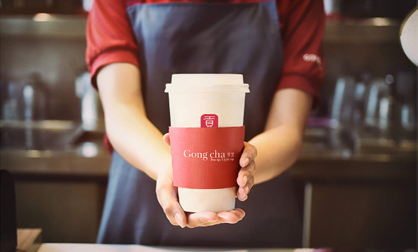Server holding cup of Gong cha beverage