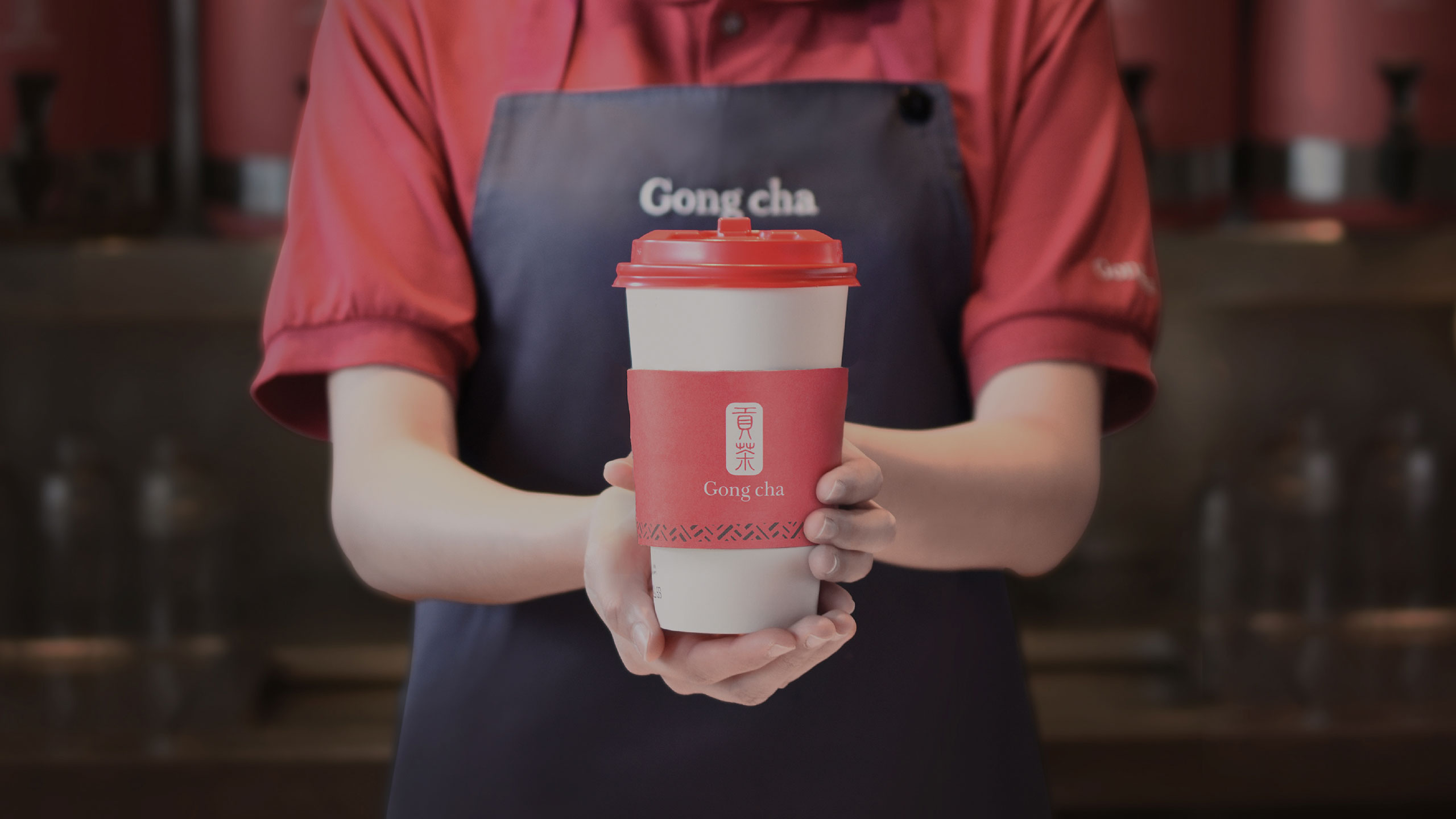 Server holding out Gong cha cup